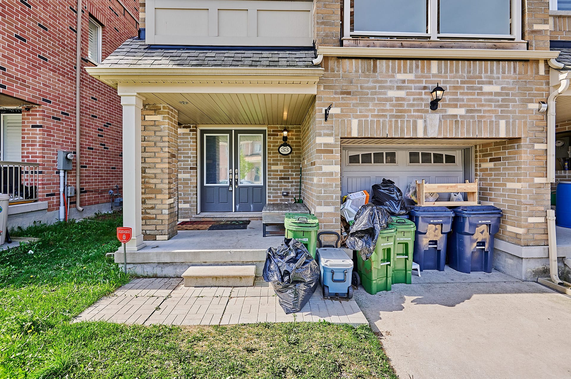 Before: GTA townhouse exterior with recycling bins and clutter blocking garage curb appeal