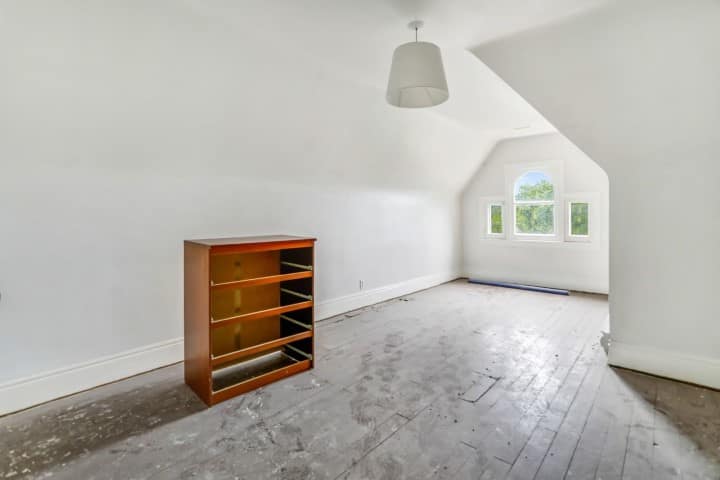 Cluttered room photo before object removal for real estate listing
