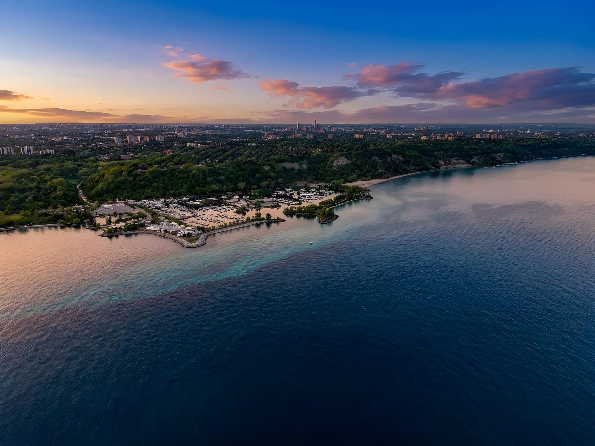 Twilight aerial edit of Scarborough Bluffs marina and Toronto skyline at sunset