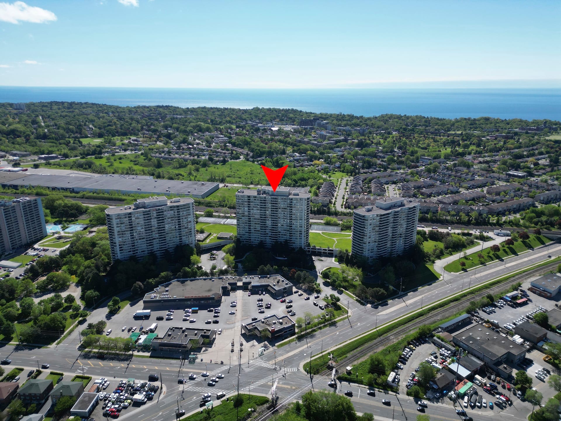 Aerial context of a Scarborough residential building near green space and Lake Ontario